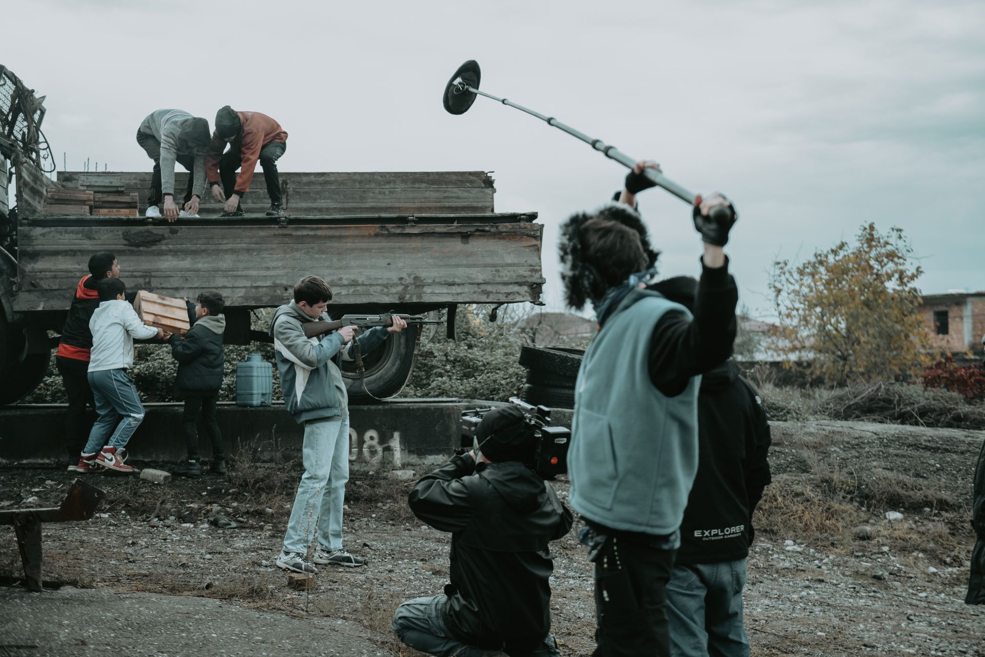 Equipe de filmagem operando câmera e microfone boom em captação
